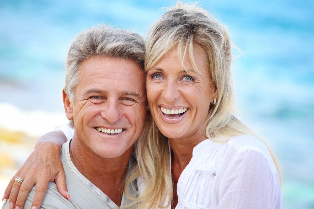 image of couple with dental implants